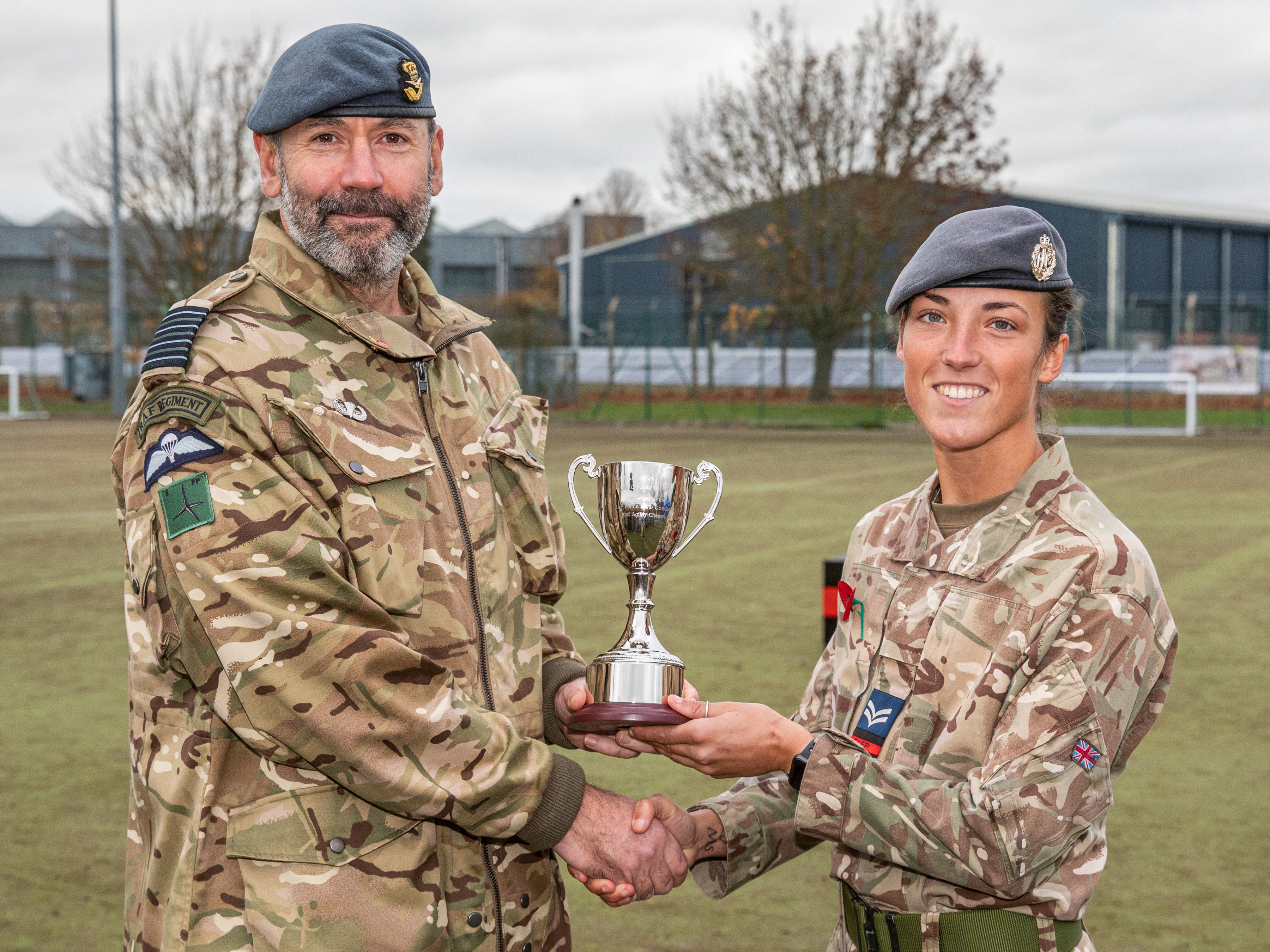 Image shows RAF Police shaking hands and accepting award.